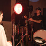 Behind the scenes of a film production with a spotlight in the dark