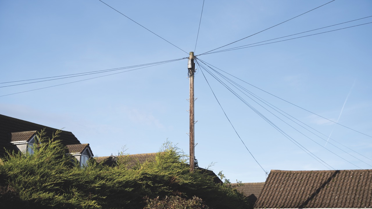 A phone mast in front of a blue sky